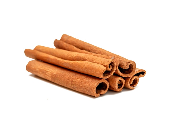 Several cinnamon sticks on a white background