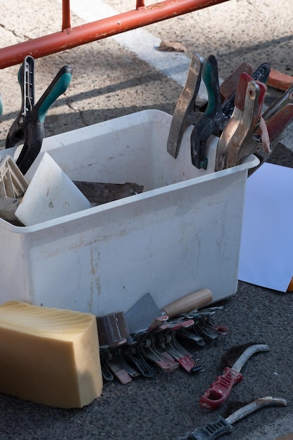 Several clamps hanging from a piece of wood await their turn to be used