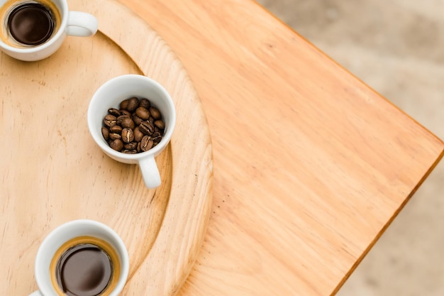 Several coffee cups on a wooden table with copy space. No people.