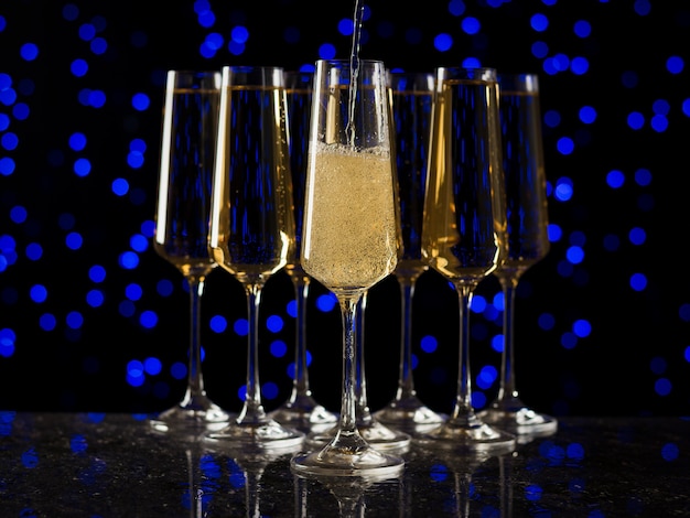 Several crystal glasses filled with sparkling wine. A popular alcoholic drink.