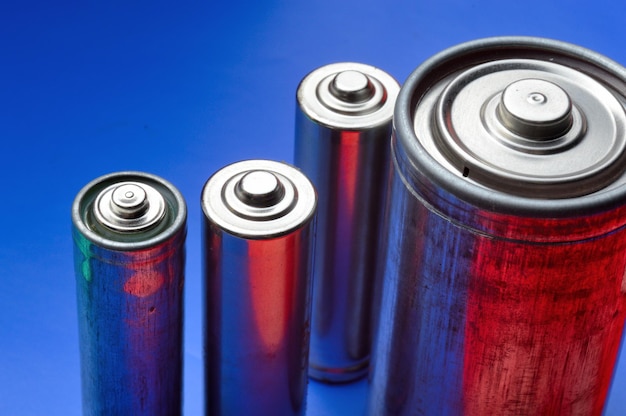 Several different batteries on a blue background. close-up.
