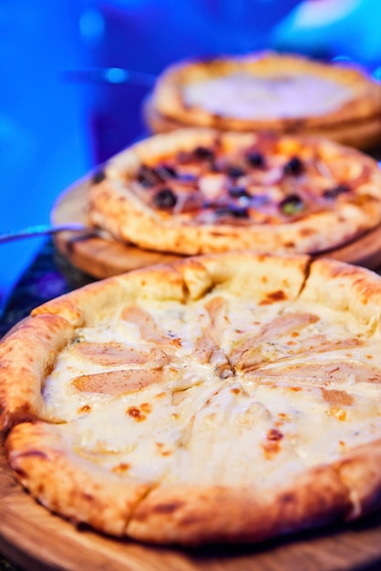 Several different pizzas on a nightclub table