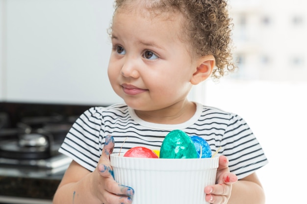 Several Easter eggs in a child's hand.