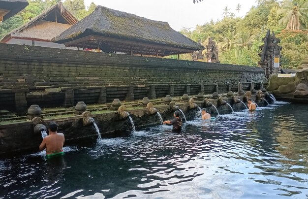 Several foreign tourists purify themselves at Tirta Empul Temple in Bali