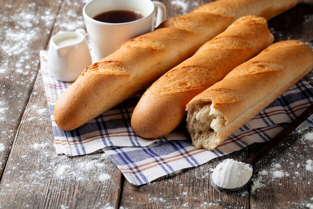 Several french baguettes with coffee and milk