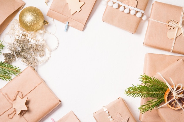 Several gift boxes wrapped in kraft paper on a white background, eco friendly christmas concept, zero waste gifts for the new year, white background, frame from boxes, copy space