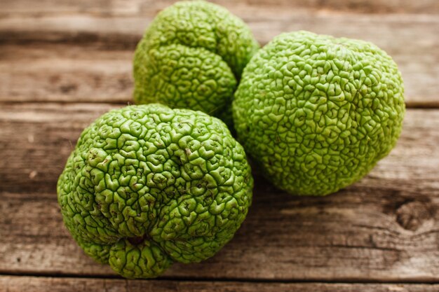 Several green adam's apples on wood closeup