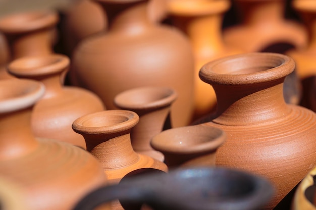 Several handmade clay pots close up backgroundxA