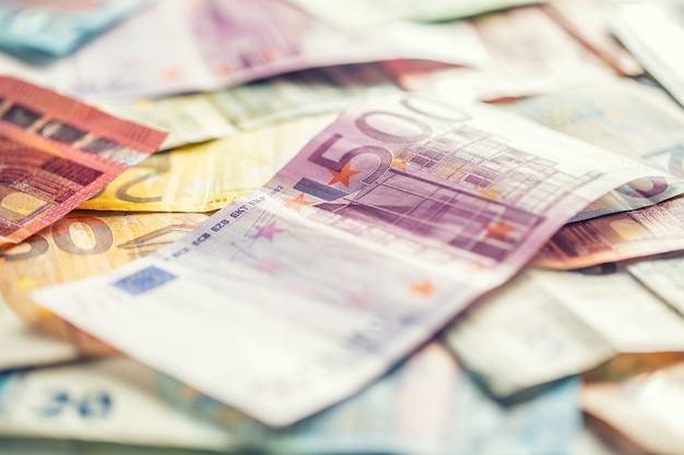 Several hundred euro banknotes stacked by value.