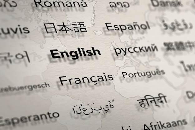 Several important languages on paper with world map background Translate and languages education