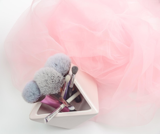 Several makeup brushes on a light pink background aesthetics of
makeup artist makeup holiday birthday beauty salon content shooting
for makeup artist