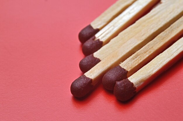 Several matches on a red background shot.