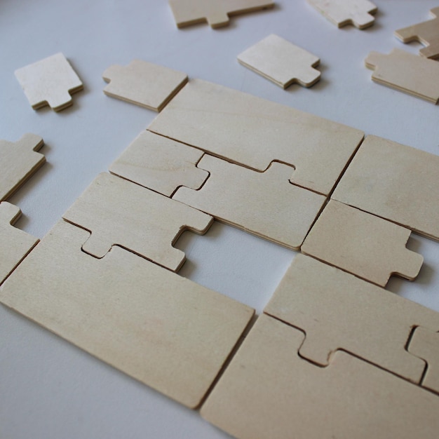 Several missing pieces in a nearly complete puzzle made from wooden fragments