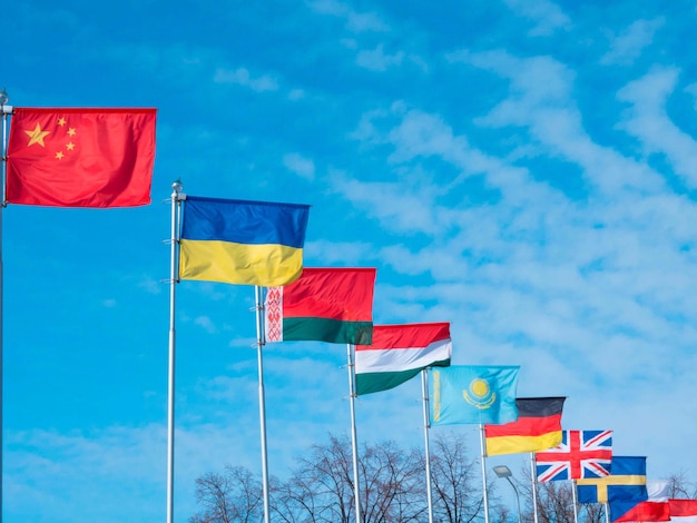 Several national flags of different countries are flying on flagpoles