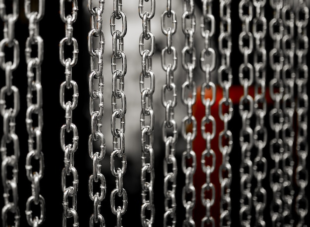 Several near chains hanging parallel to each other with sides in the background. High quality photo