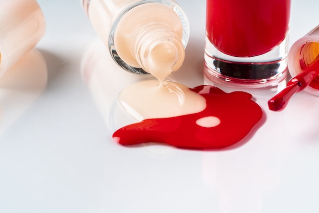 Several opened bottles of nail polish on white background