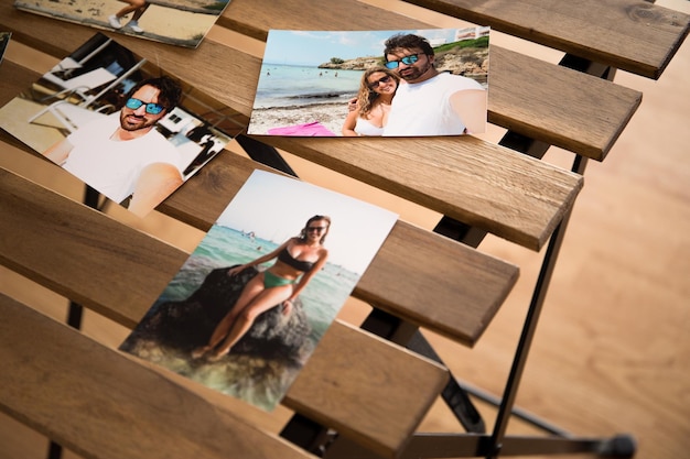 Several photos of a couple on the beaches of mallorca. on a\
wooden table with holes in it.