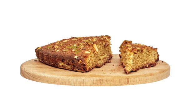 Several pieces of homemade sponge cake with nuts on a wooden cutting boardxA