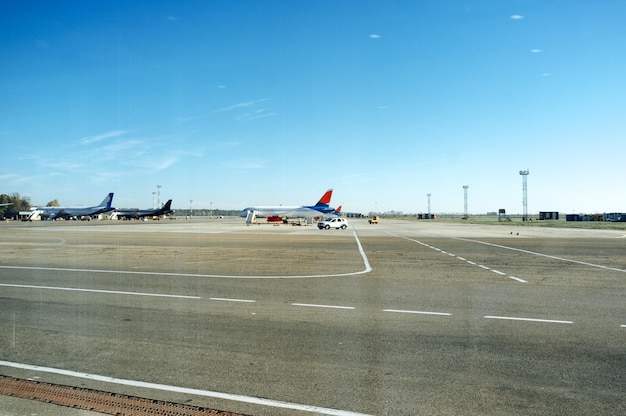 Several planes parked at the airport on loading