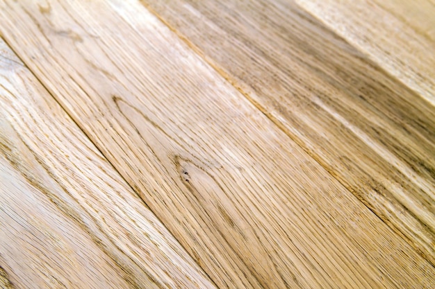 Several planks of beautiful laminate or parquet flooring with wooden texture as background