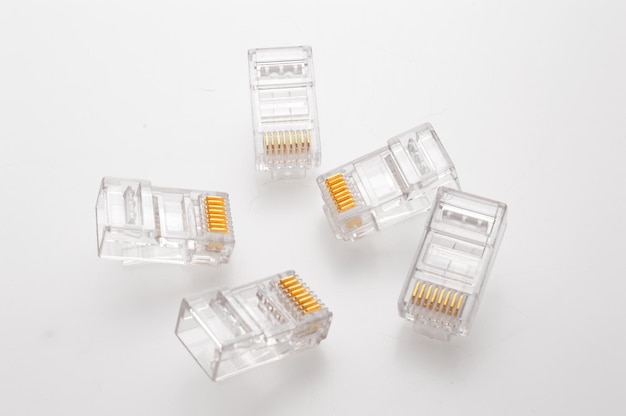 Several rg 45 connectors for internet cables lie on a light background Closeup