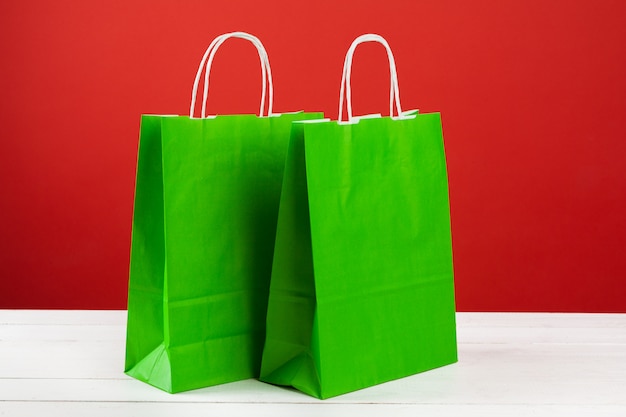 Several shopping bags with copy space on red background