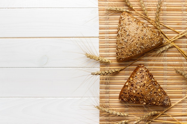 Several small multi grain triangular shaped bread sprinkled with whole sunflower seeds