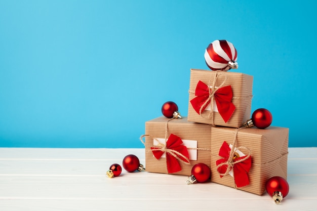 Several stacked Christmas gifts in festive wrapping