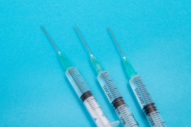 Several syringe on blue table