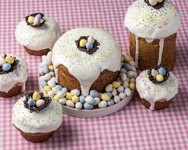 Several traditional Easter cakes or sweet bread and candy eggs decorated homemade pastry top view