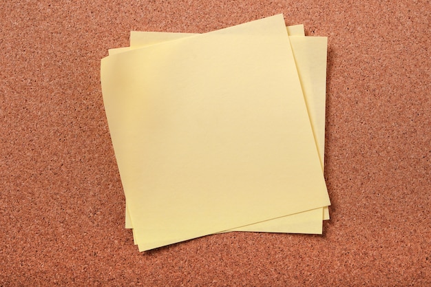 Several untidy sticky post notes on cork board