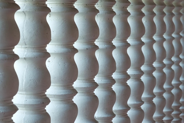 Several white curved columns in one row