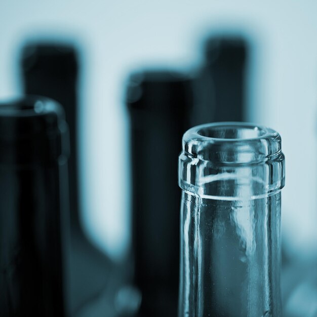 several wine glass bottles in blue color