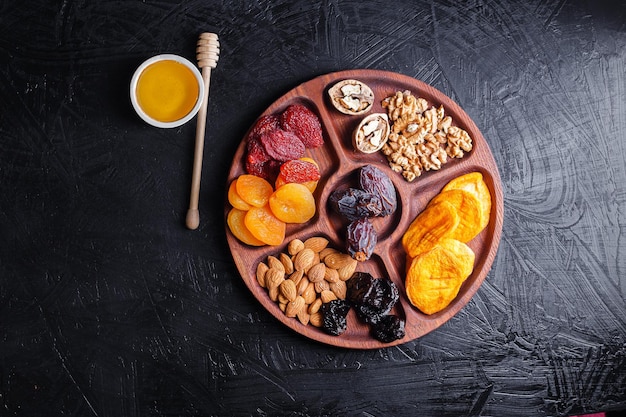 several wooden tray, menagerie with dried fruits, nuts, sausages with cheese, grapes with biscuit