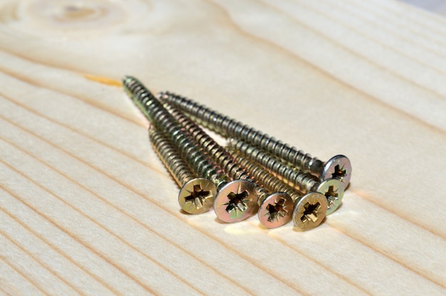 Several yellow self-tapping screws