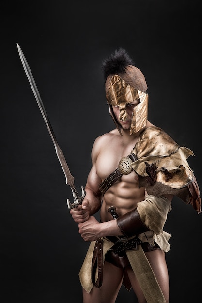 Severe barbarian in leather costume with sword