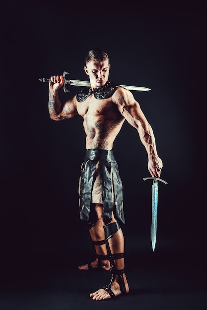 Photo severe barbarian in leather costume with sword