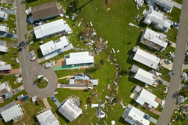 Photo severely damaged by hurricane ian houses in florida mobile home residential area consequences of natural disaster