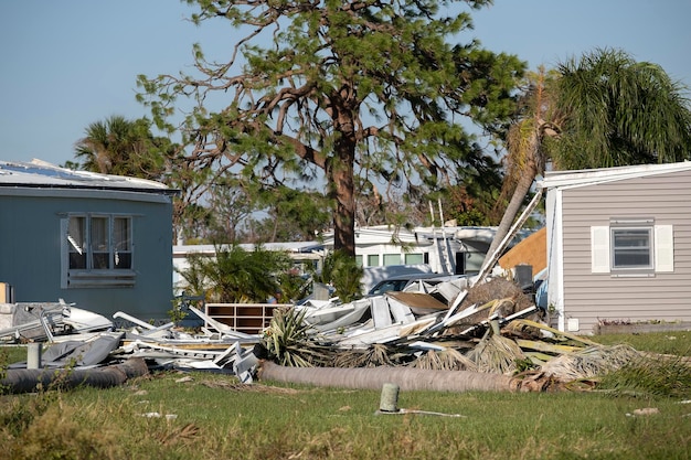 Photo severely damaged houses after hurricane ian in florida mobile home residential area consequences of natural disaster