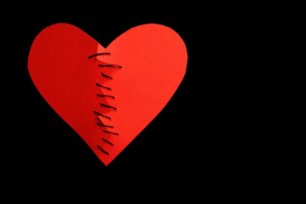 Photo sewed heart on black background