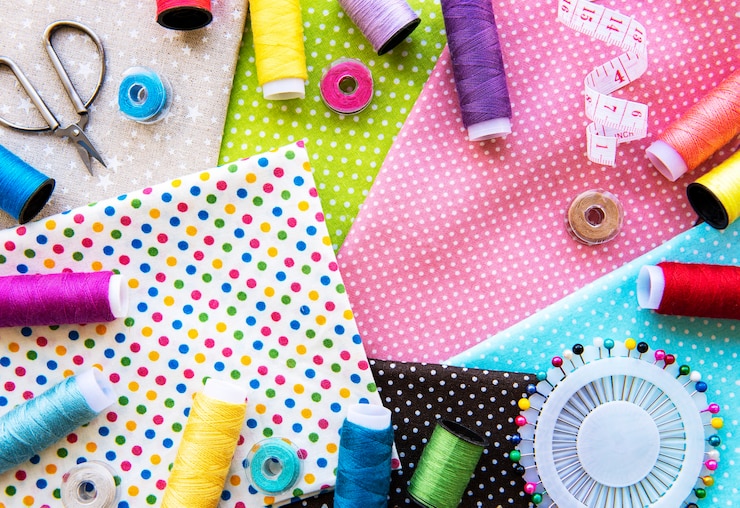 Photo sewing accessories and fabric. top view, flat lay.