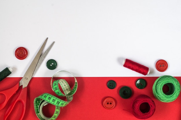 Sewing accessories in red and green colors. Top view