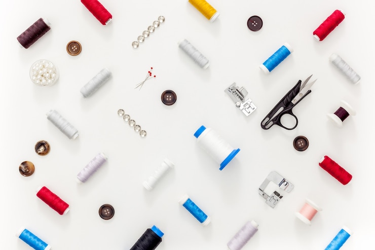 Photo sewing accessories and sewing supplies. spools of thread, scissors and centimeter