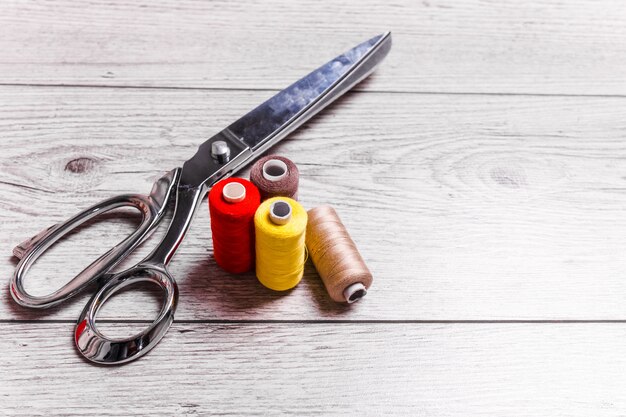 Sewing accessories on wooden background.