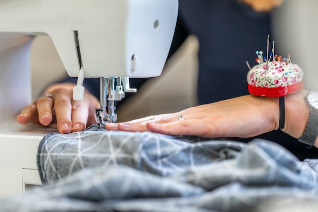 Sewing cloth on a sewing machine in a tailor shop.