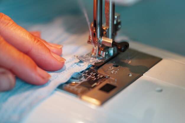 Sewing clothes on a sewing machine close-up.