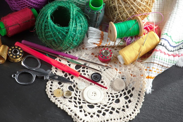 A sewing kit is on a table with a sewing needle and a sewing needle.