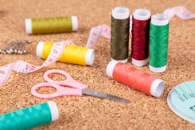 Sewing kit with colorful spools of threads and instruments