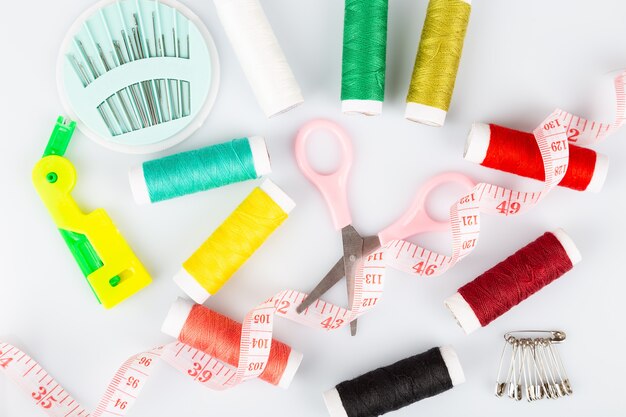 Sewing kit with colorful spools of threads and instruments