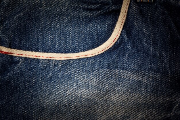 Sewing line of vintage blue jeans